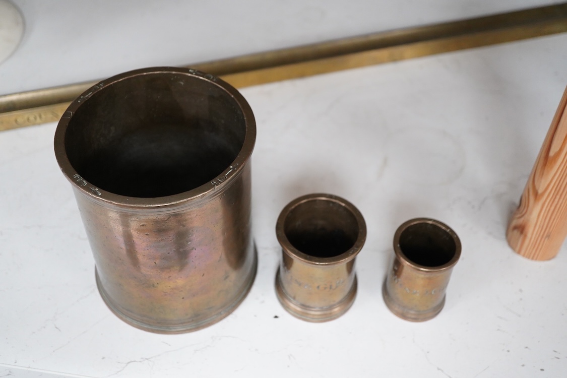 Three 19th century bell metal wine gill measures, two smaller examples engraved; ‘wine hill’, tallest 13.5cm